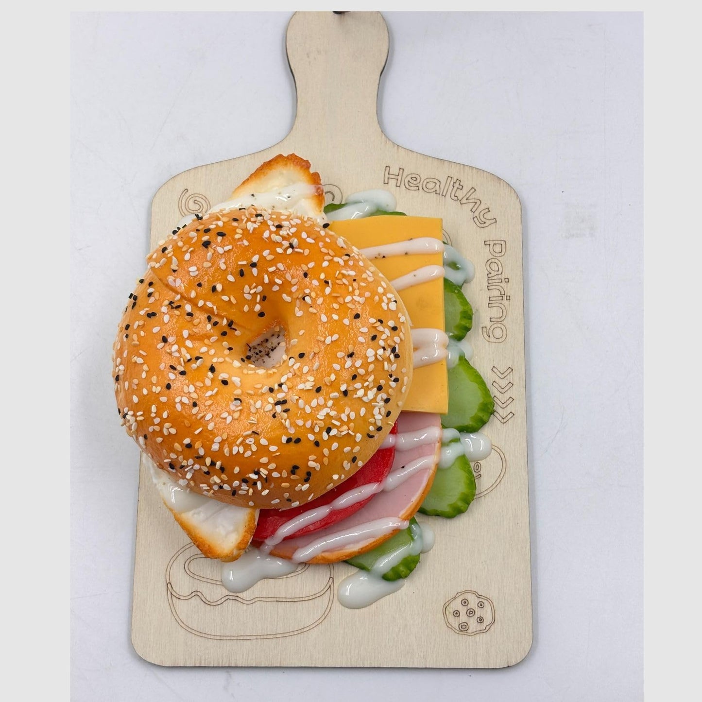 GURUBHAI EQUIPMENTS Artificial Bagel Sandwich with Cheese & Egg – Realistic Fake Food Prop with Wooden Board for Café Display, Bakery Showpiece, Photography & Restaurant Décor